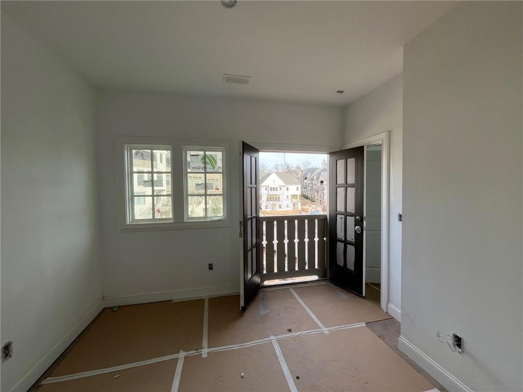 The upstaris secondary bedroom has a juliet balcony overlooking the front of the home.