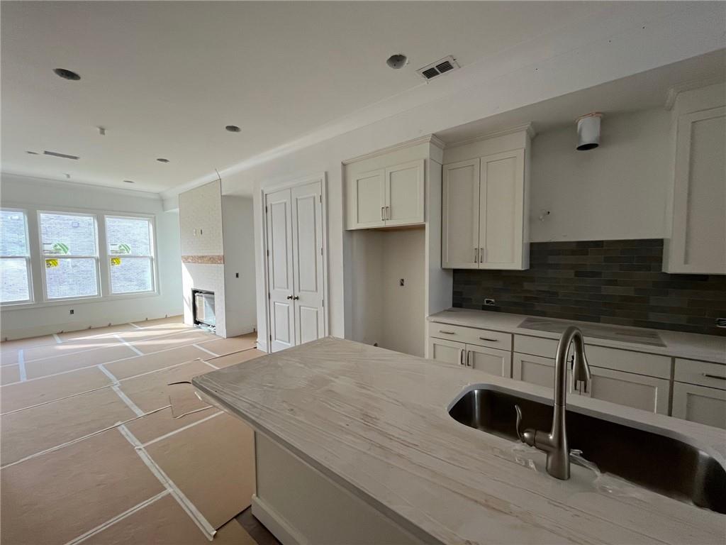 View of kitchen to family room on main level of this home. Enjoy the 12 foot island!