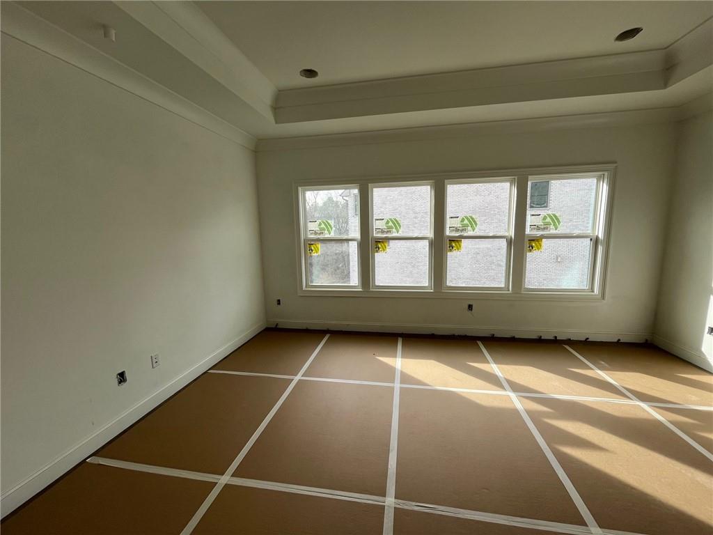 The Primary Suite offers hardwood floors, trey ceiling and can lighting.