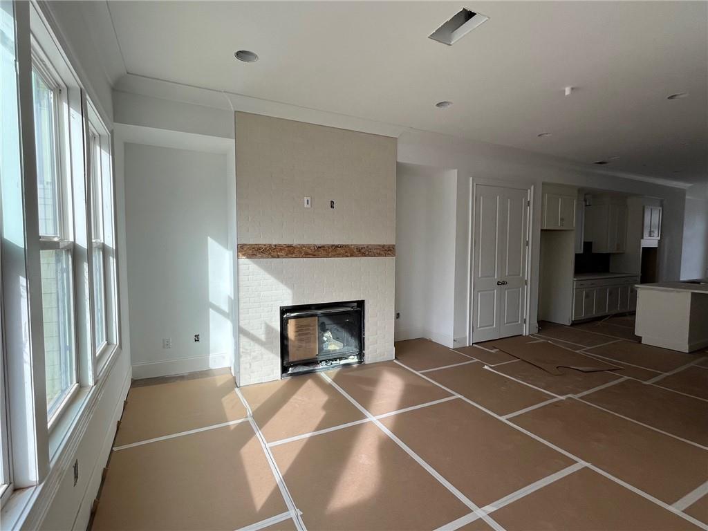 The central fireplace in this home has tiled to ceiling tile with a free floating mantel.