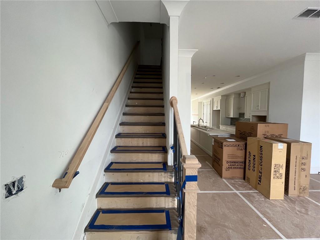 Stairs off main level with oak treads and painted risers.