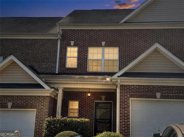 Brick exterior facade with light siding accents
