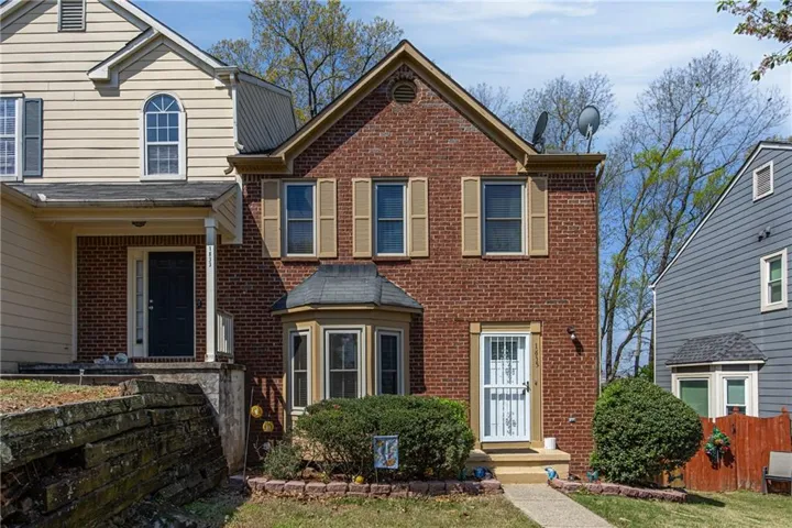Brick facade with bay window and shuttered windows