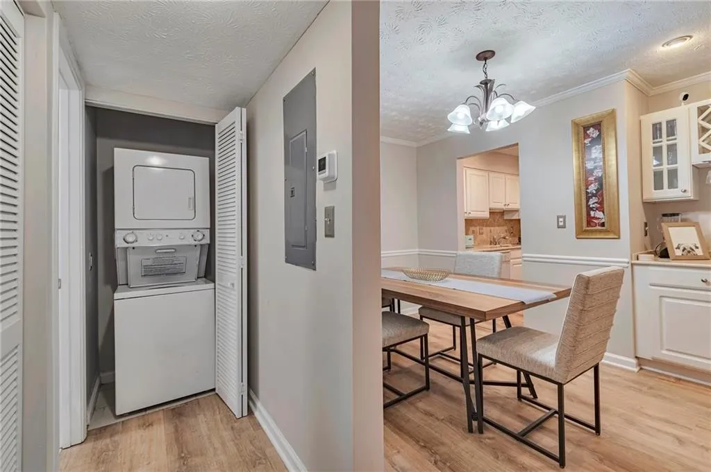 Laundry area features stacked washer/dryer tucked behind bi-fold doors when not in use.