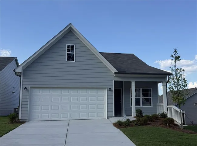 Light blue siding exterior with a dark roof and white trim