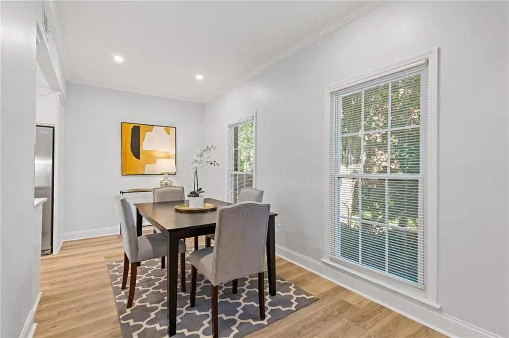 Eat in Kitchen area featuring crown molding, light wood finished floors, and recessed lighting