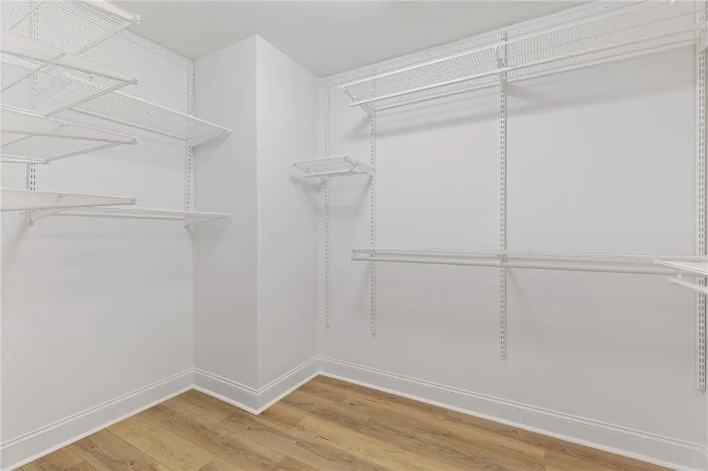 Spacious closet with light wood finished floors
