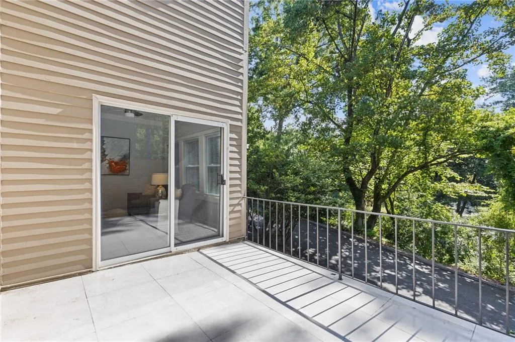Balcony featuring view of scattered trees