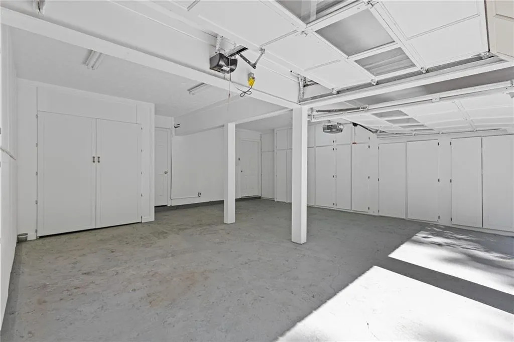 Garage with a garage door opener and LOTS of storage space