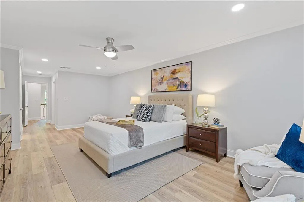 Bedroom featuring recessed lighting, ornamental molding, light wood-style floors, and a ceiling fan
