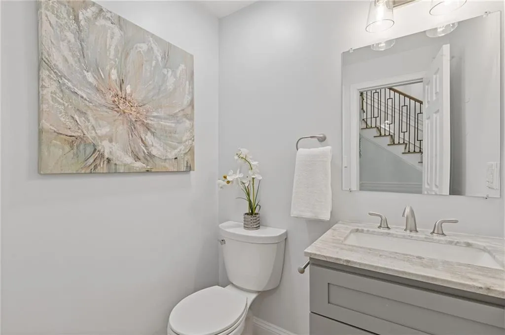Half bathroom featuring toilet and vanity