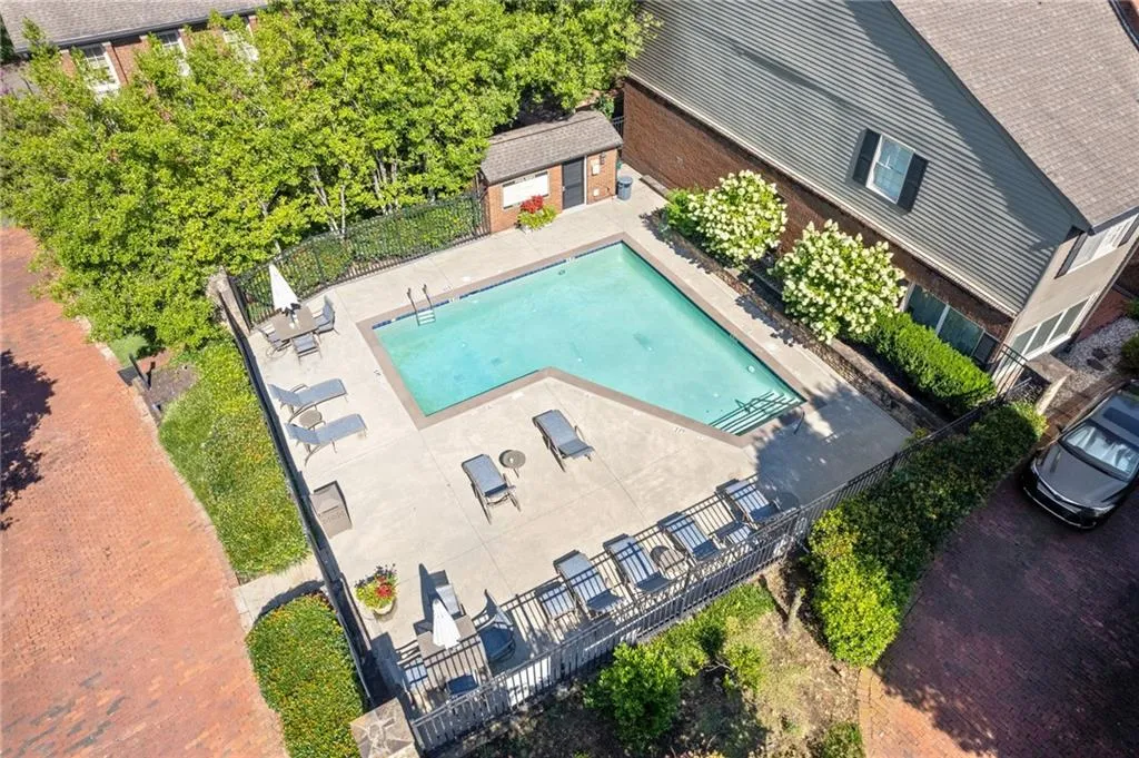 Aerial view of property and surrounding area with a pool
