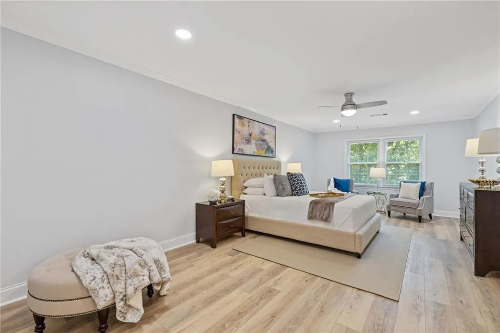 Bedroom with crown molding, light wood-type flooring, recessed lighting, and ceiling fan