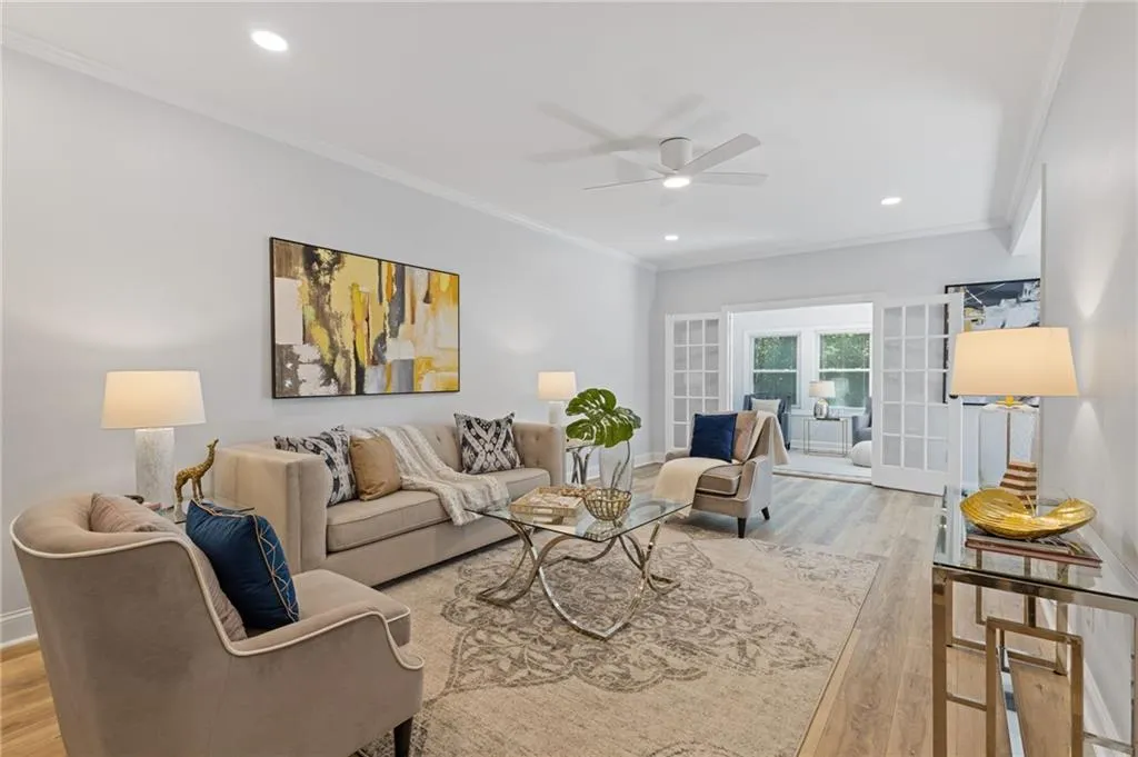 Living area featuring ornamental molding, a ceiling fan, recessed lighting, and wood finished floors
