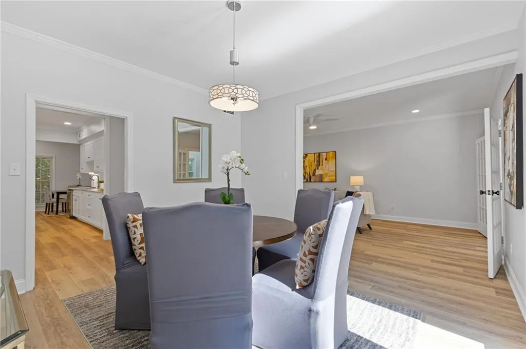 Dining room with ornamental molding, light wood-style flooring, a ceiling fan, and recessed lighting