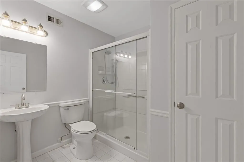 Full bath with a stall shower and tile patterned floors