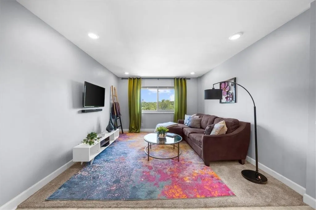 Carpeted living area featuring recessed lighting