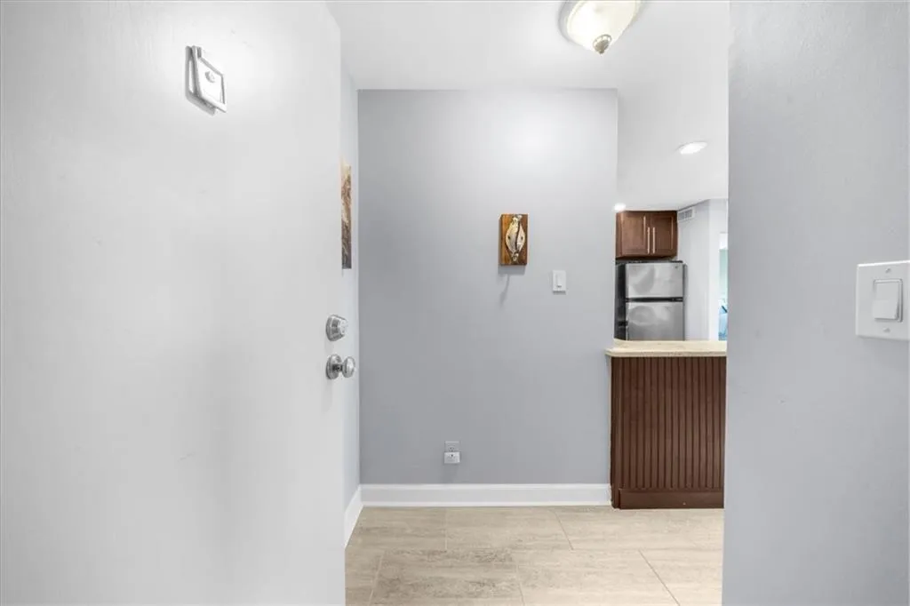 Entry with baseboards and light tile patterned flooring