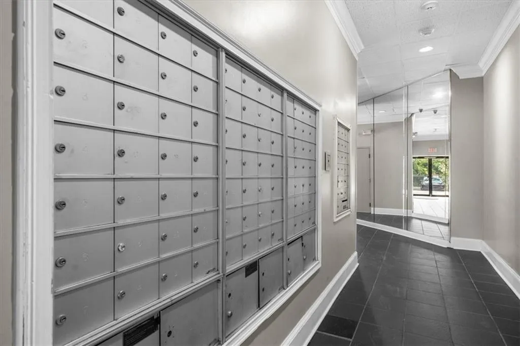 View of mail area, crown molding, and recessed lighting