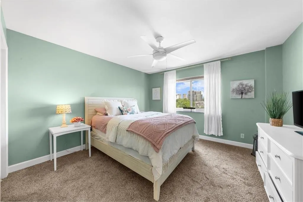 Bedroom featuring light colored carpet and ceiling fan