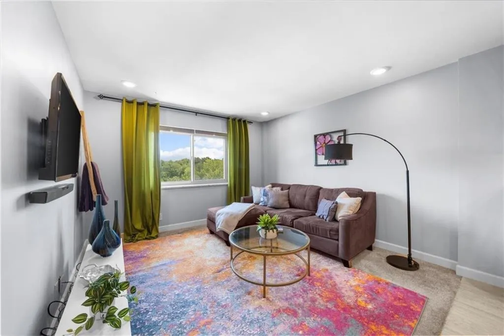 Carpeted living room with recessed lighting
