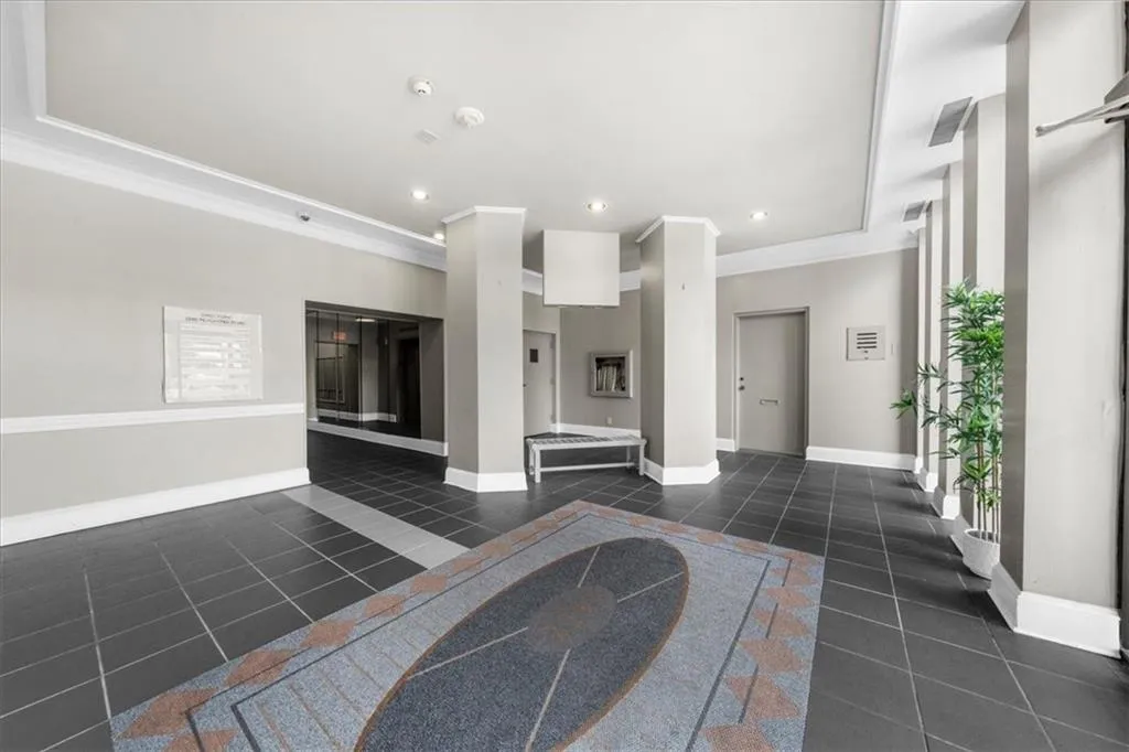 Lobby with crown molding and recessed lighting
