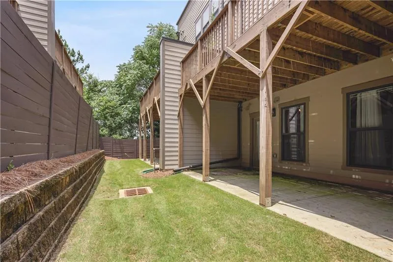 View of yard featuring a deck and a patio area