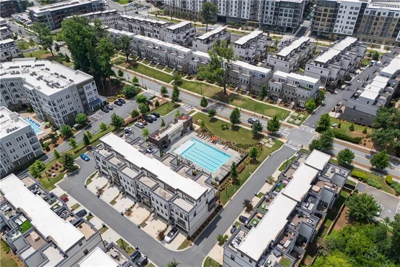 Aerial view of property's location with a pool area and nearby urban area
