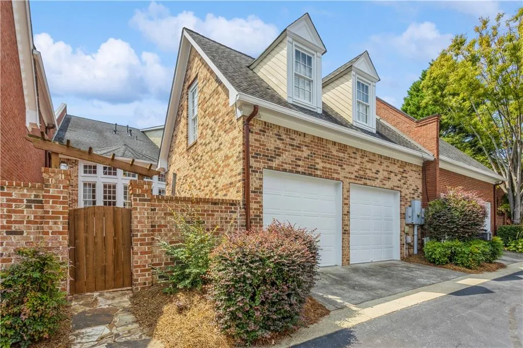 Rear entry garage and gate to private courtyard.