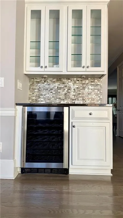 Bar with storage for stemware and a beverage fridge.