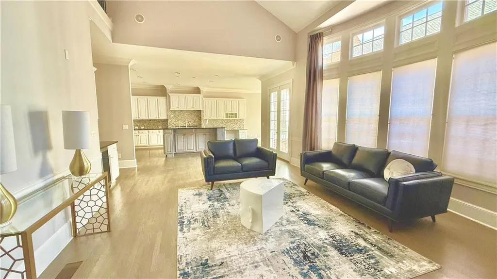 Vaulted great room open  to the eat-in kitchen with large island and tons of cabinets.