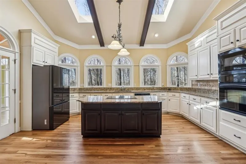 The Chef's Kitchen is a dream with Granite Countertops, White Cabinetry, A Large Island, and Skylights that bathe the space in Natural Light.