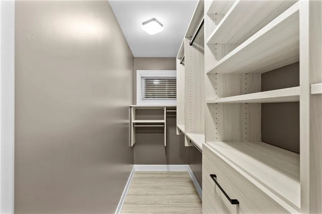 Spacious closet with light wood-type flooring