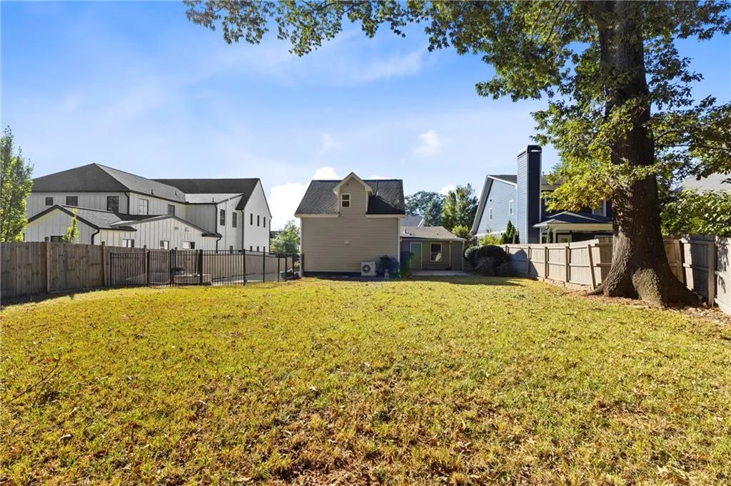 Fenced backyard featuring a residential view