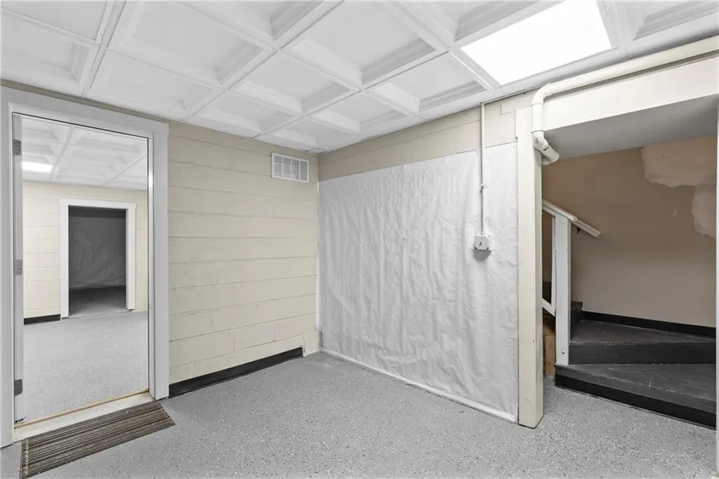 Basement featuring concrete block wall