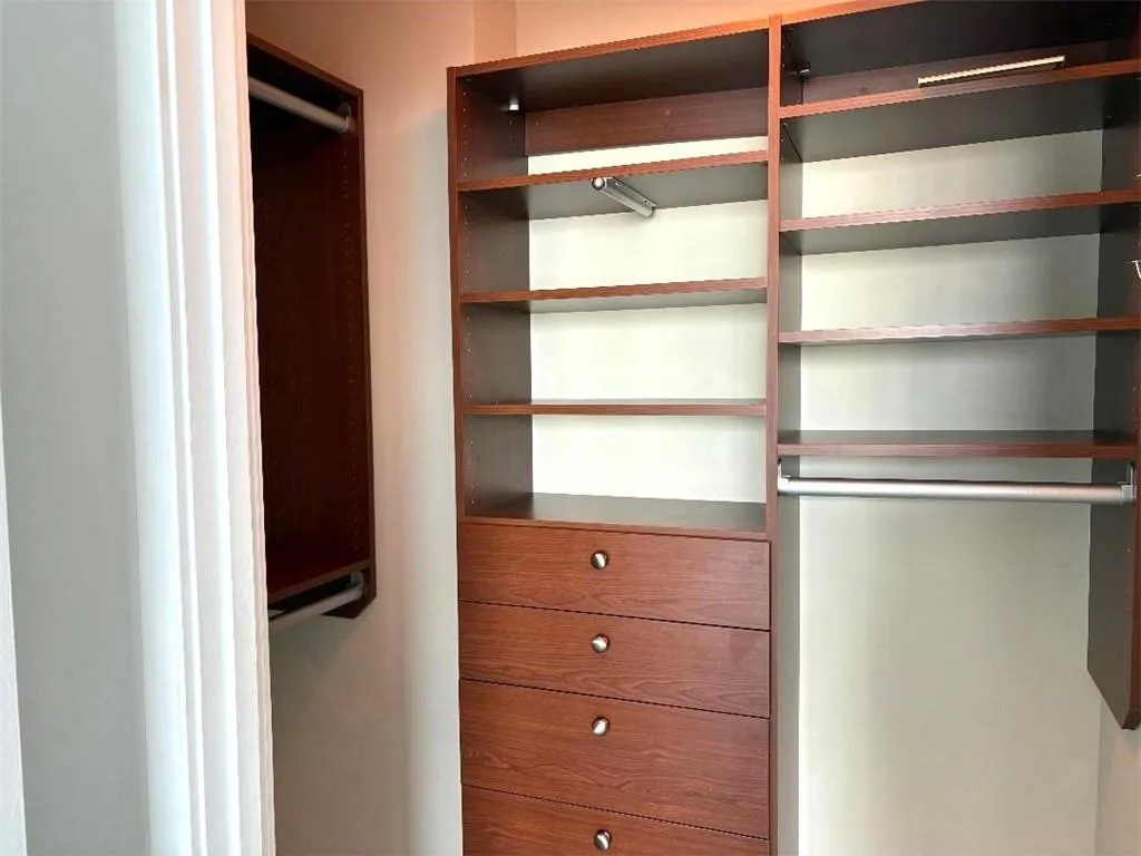 View of walk in closet Customized Closet in Primary Suite