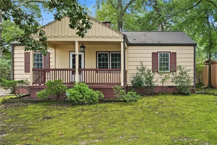 Front exterior featuring horizontal siding, a covered porch with a railing, a gabled roofline, and multiple windows with shutters