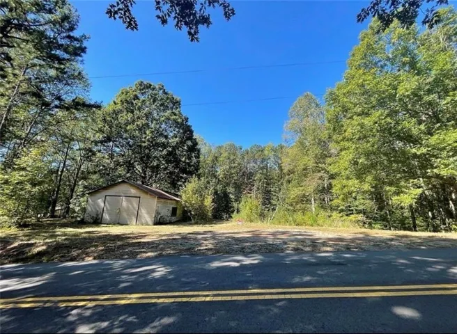 Road frontage with a separate structure and mature trees