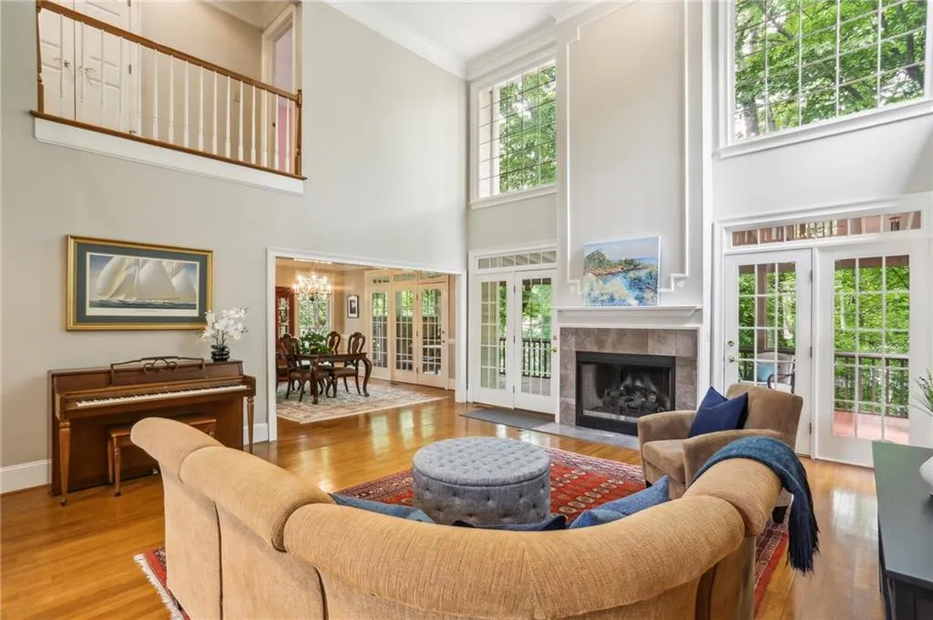 Such amazing views and natural light. It's a wall of green out the back windows in this impressive and expansive living room.