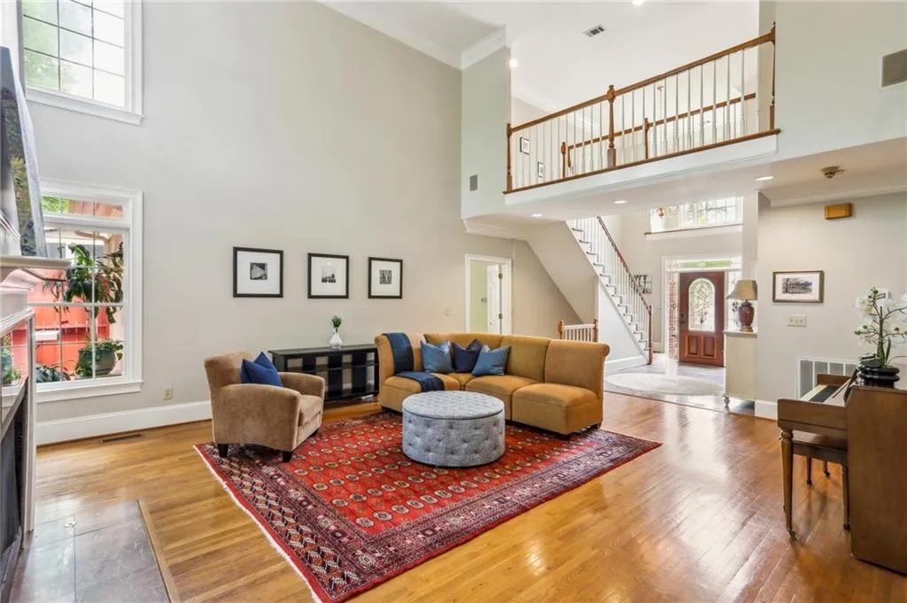 The living room features gleaming wood floors and amazing light.