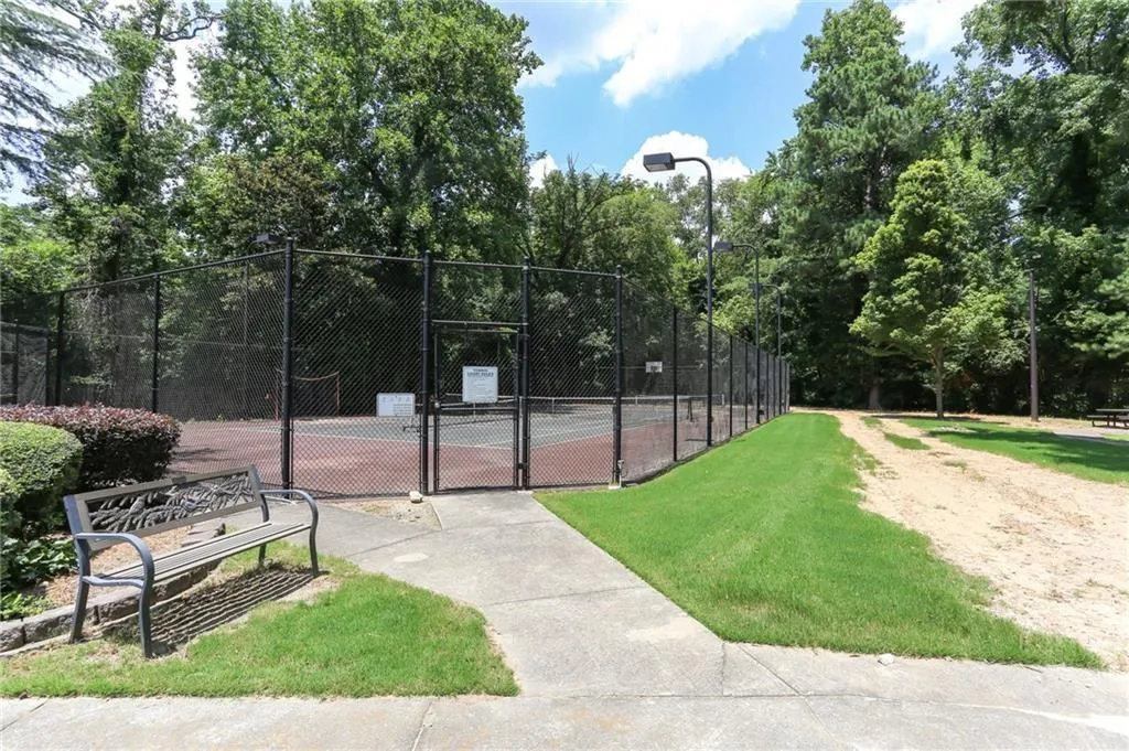 View of tennis court with a gate