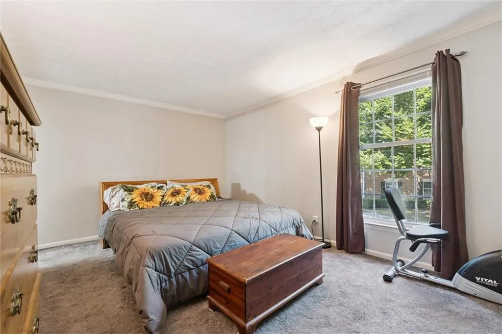 Bedroom featuring crown molding and carpet floors