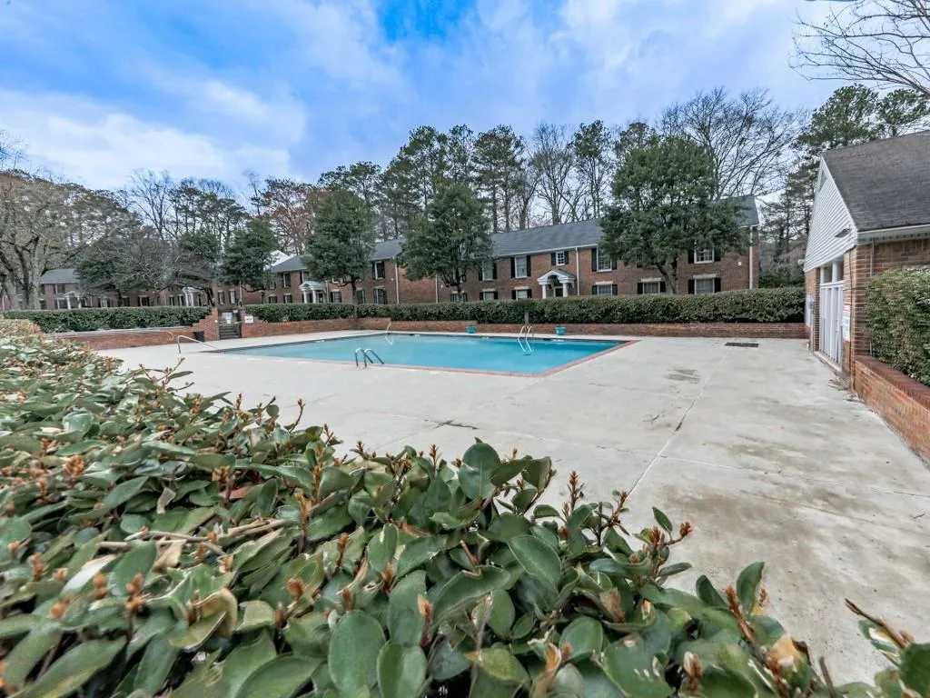Community pool with a patio