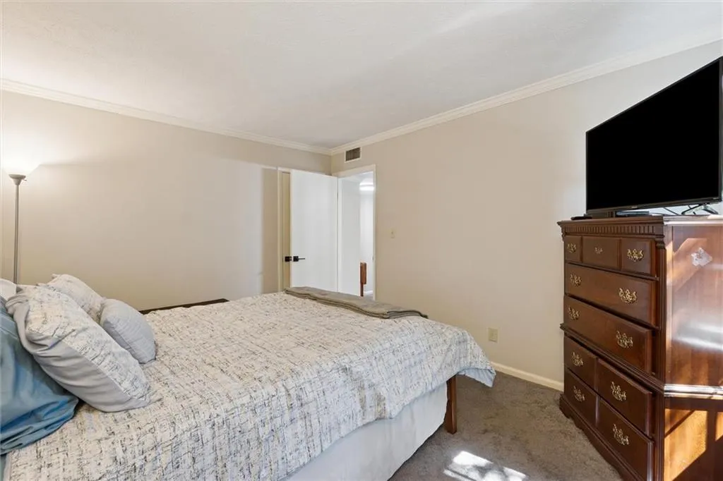 Bedroom featuring carpet floors and ornamental molding