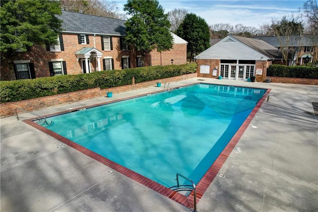 Community pool featuring a patio and an outdoor structure
