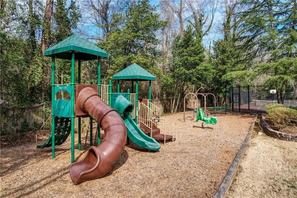 Community jungle gym featuring view of wooded area