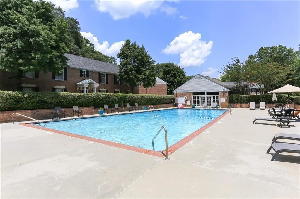 Community pool with a patio