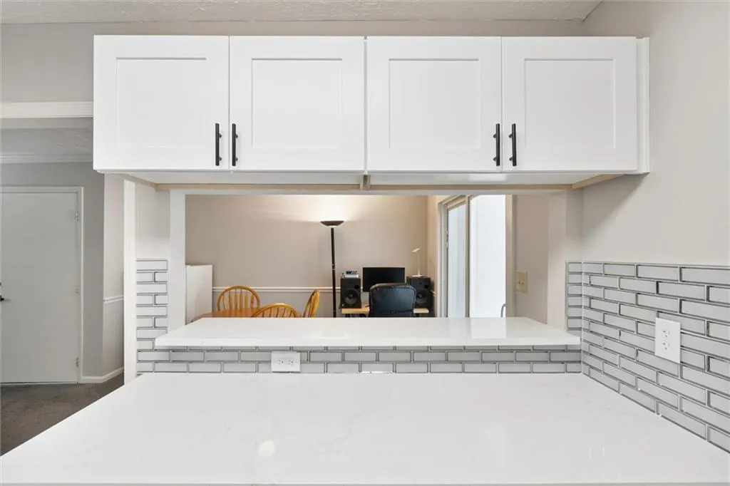 Detailed view of light stone countertops and white cabinets