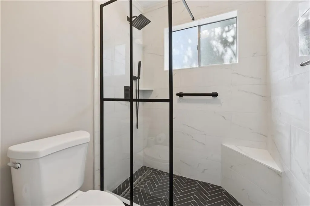 Bathroom featuring a stall shower and toilet