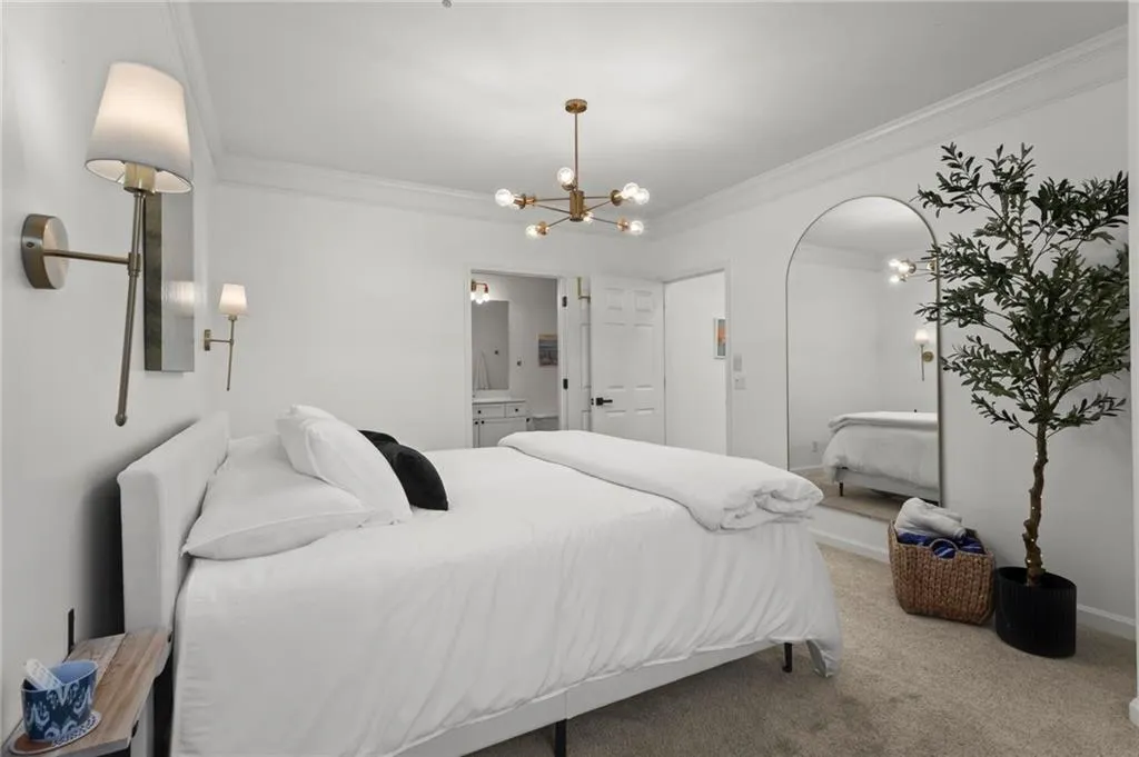 Primary bedroom with alcove for office space, and ensuite bathroom.